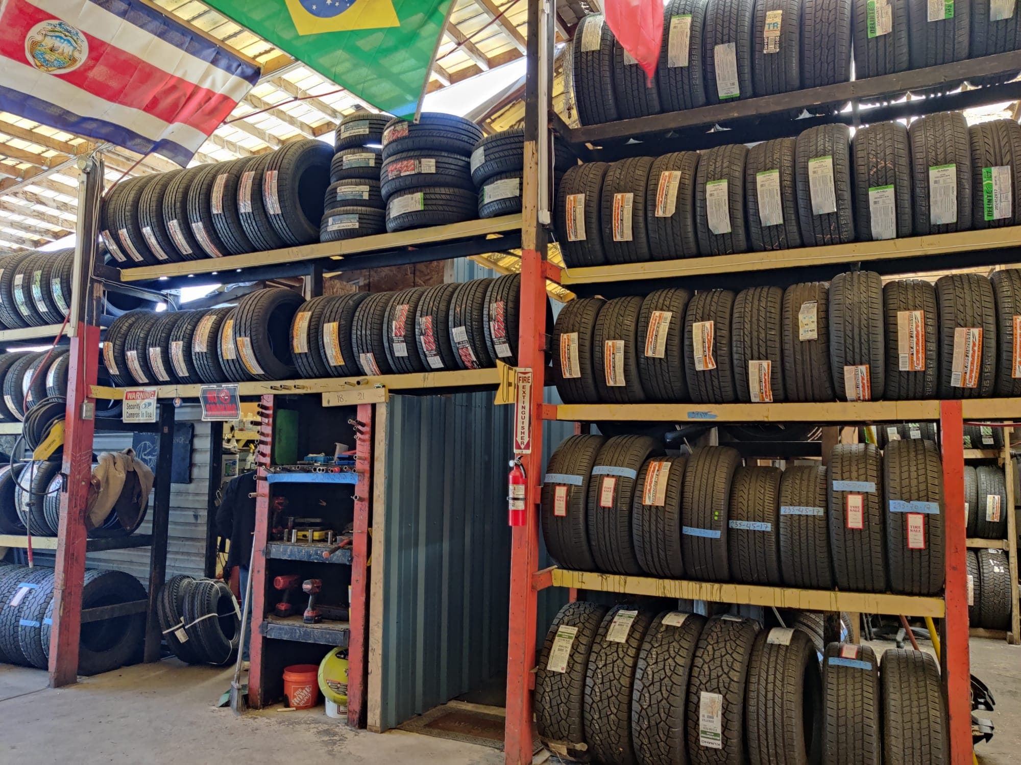 Inside the Mayo RD tire shop in Edgewater, MD — racks stacked with new and quality used tires ready for same-day installation.